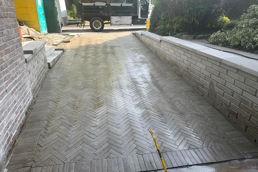 Herringbone interlock driveway between two retaining walls