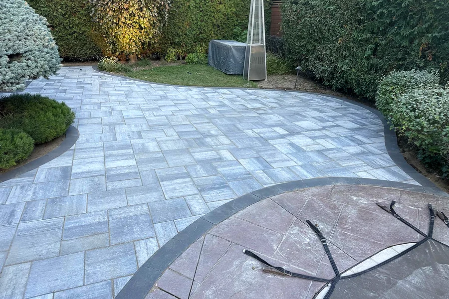 Grey interlock patio with a curved charcoal border